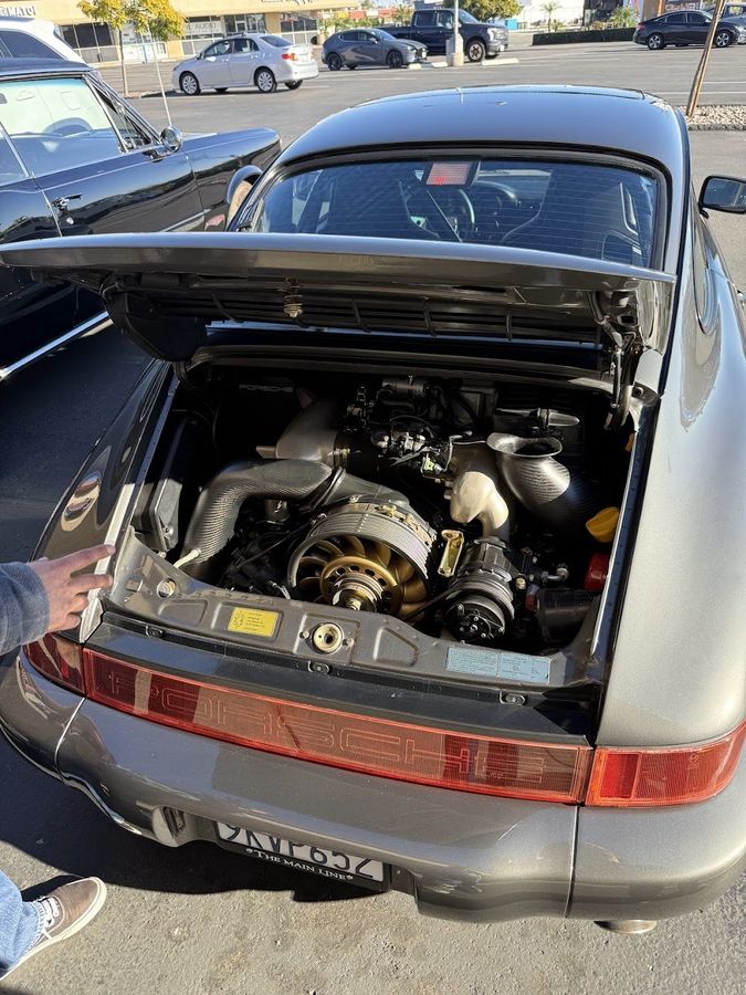 Silver Porsche with its engine bay open at the Pet Zone meetup